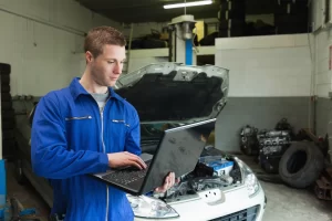 Mechanic is using a laptop